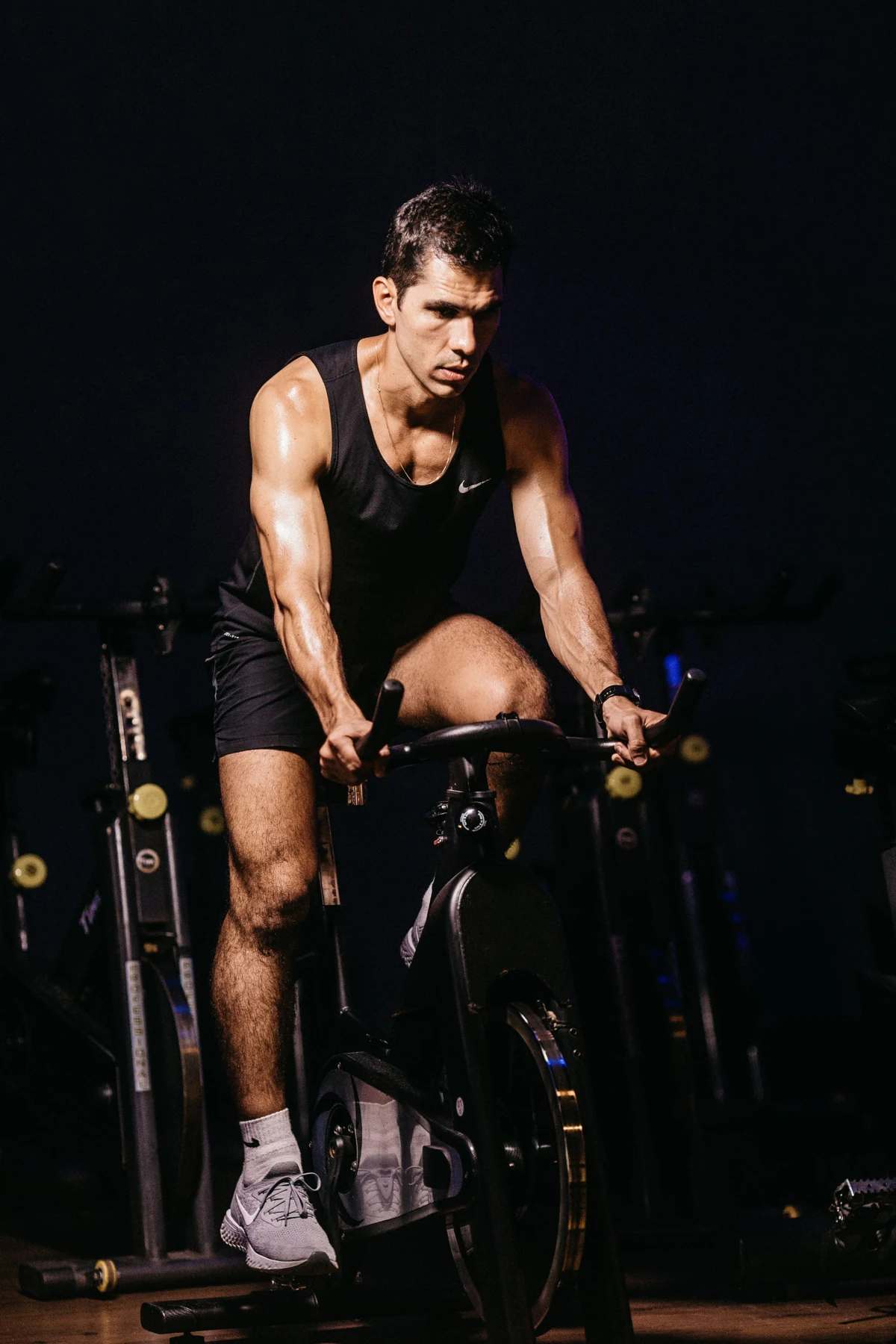 Homem pedalando em uma bicicleta de spinning